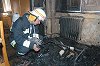 Tűzoltó vizsgálódik a levéltárban - a tűz oka elektromos zárlat.  Fotó: Vidovics Ferenc, 2003.06.12.